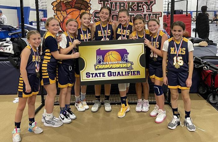Members of Mars Girls Youth Basketball Mars Gold Team Camryn Bartle, Avi Rocco, Addi Schaerer, Addy Hainan, Talia Sanata, Kate Sherwin, Alyssa Day, Lila Edwards, and Gia Ginocchi celebrate after taking first place at the New Castle Turkey Shootout Tournament